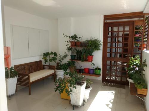 a living room filled with lots of potted plants at Cantinho Aconchegante 304 Praia - Tambaú in João Pessoa