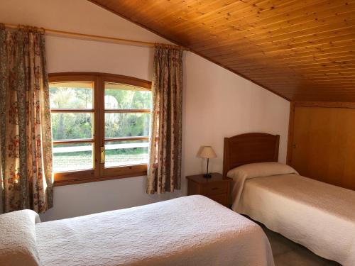 A bed or beds in a room at Casa Fontanals