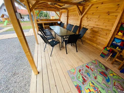 a wooden deck with a table and chairs in a cabin at UBYTOVÁNÍ S WELLNESS in Dolní Dobrouč