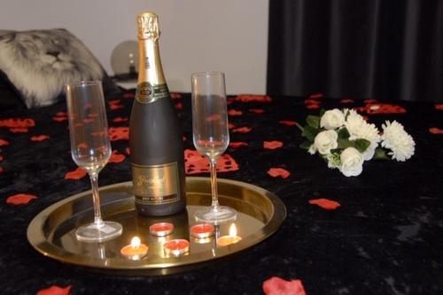 a bottle of champagne and two glasses on a table at Apartamento a primera linea de mar en platja d’aro in Platja  d'Aro