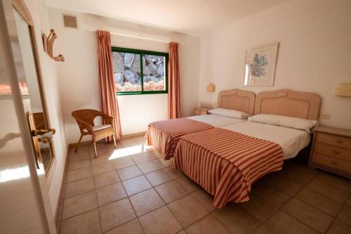 ein Schlafzimmer mit einem großen Bett und einem Fenster in der Unterkunft Bungalow Villa Verde 2 in El Paso