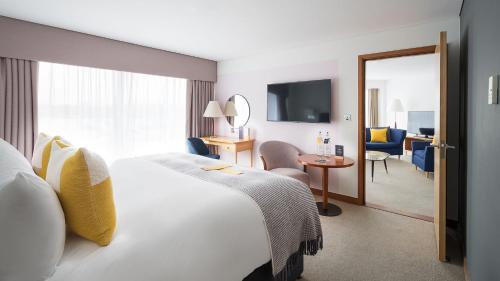 a hotel room with a bed and a living room at voco Reading in Reading