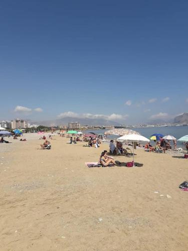 a group of people laying on a beach at Ciccio Rooms and breakfast - Self check-in in Palermo