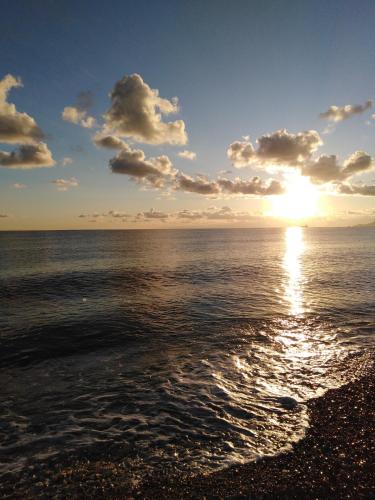 a sunset over the ocean with the sun setting at Ciccio Rooms and breakfast - Self check-in in Palermo
