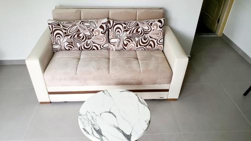 a couch in a living room with a table at Ressa Apart in Marmaris