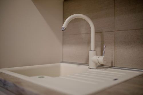 a white sink with a faucet in a bathroom at Villa Luka Lopar in Lopar