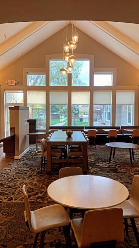 a large room with tables and chairs and windows at Sonesta ES Suites Parsippany Morris Plains in Parsippany