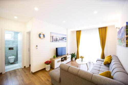 a living room with a couch and a television at Milara Apartments in Budva