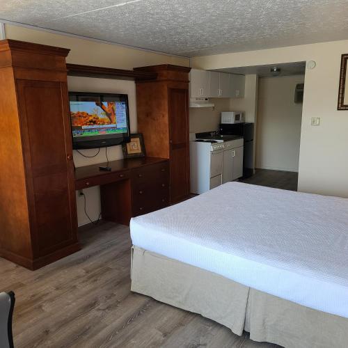 a hotel room with a bed and a flat screen tv at Oceanfront Twilight Surf Hotel in Myrtle Beach