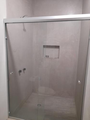 a shower with a glass door in a bathroom at Grand View Suites in Manzanillo