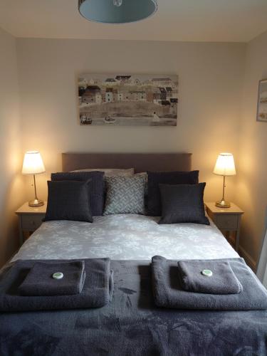 a bedroom with a bed with two towels on it at Number 7 The Cottage A Rural Retreat in Durham