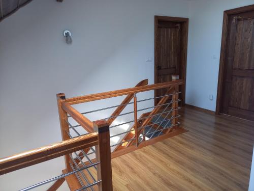 a staircase in a room with a wooden floor at Zagroda na Borach in Jabłonka
