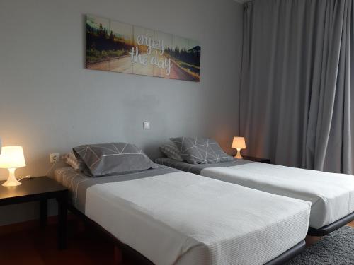 Dos camas una al lado de la otra en un dormitorio. en Apartamentos América - Blue Sea, en Funchal
