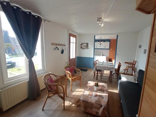 a living room with a couch and a table at Au Pied Des Remparts in Saint-Valery-sur-Somme