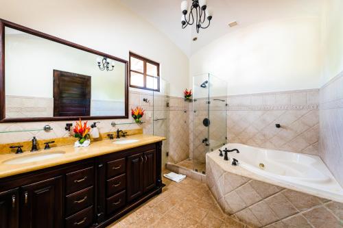 a bathroom with a tub and a sink and a bath tub at Dream House in prestigious Hacienda Pinilla in Tamarindo