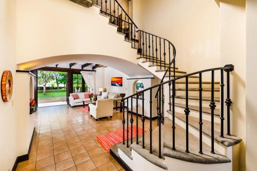 a staircase in a house with a living room at Dream House in prestigious Hacienda Pinilla in Tamarindo
