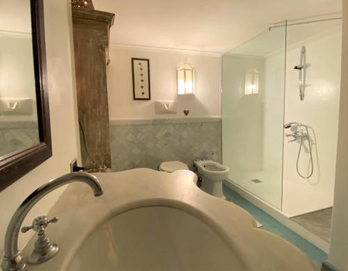 a bathroom with a tub and a toilet and a shower at Gioielli Di Priori in Perugia