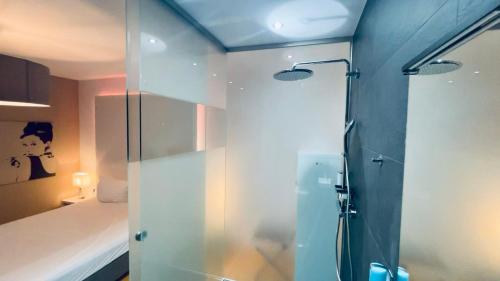 a bathroom with a shower with a glass door at smart&beautiful Guesthouse in Nordkirchen
