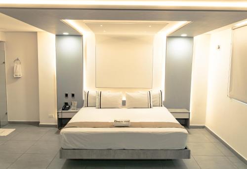 Ένα ή περισσότερα κρεβάτια σε δωμάτιο στο Mandala Hotel Medellin
