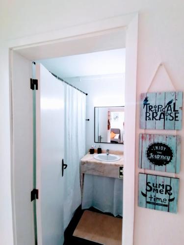 a bathroom with a sink and a mirror at Lovely apartment 500 m walk to the beach in Portimão