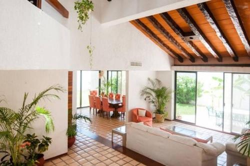 a living room with a couch and a table at Cancun Villa Agave, access to the Beach! in Cancún