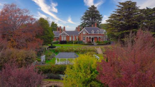 an aerial view of a large house with a garden at Arcoona Manor in Deloraine