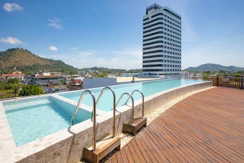 a row of walkways leading to a large swimming pool at EcoLoft Hotel - SHA Plus in Phuket