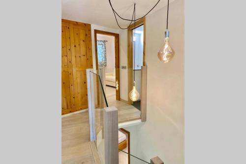 a staircase in a house with a light fixture at Comfort and sunshine in Celerina Chesa Prasura in Celerina