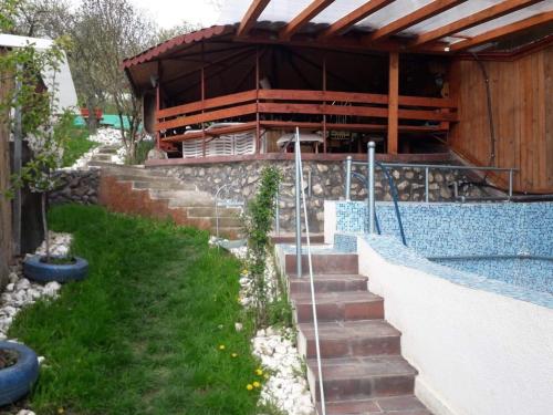 a swimming pool with stairs next to a building at Casa ROOL in Turda