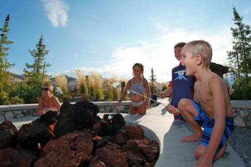 a group of people standing around a fire pit at Lake Escape #99 in Chelan