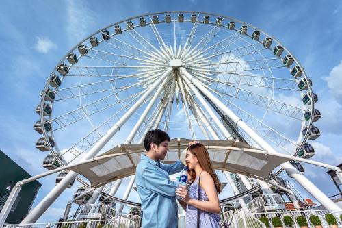 a couple standing in front of a ferris wheel at Holiday Inn Express Bangkok Sathorn by IHG in Bangkok