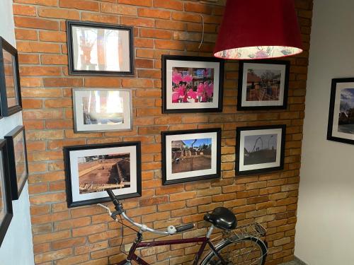 a brick wall with pictures on a wall with a bike at Apartamenty u Harrego BOUTIQUE SPA z klimatyzacja, balkon, sauna, tężnia parking in Kudowa-Zdrój