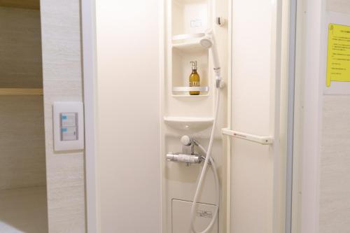a bottle of wine is sitting in the corner of a room at Hotel San Hiroshima in Hiroshima