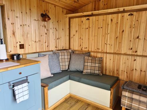 a room with a bench in a wooden cabin at Peak District Shepherds Hut in Hope