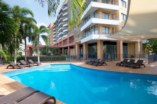 a swimming pool in front of a building at Mantra on The Esplanade in Darwin