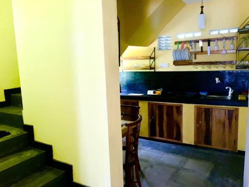 a kitchen with a sink and a counter top at Owl's Nest Chalet in Udawalawe