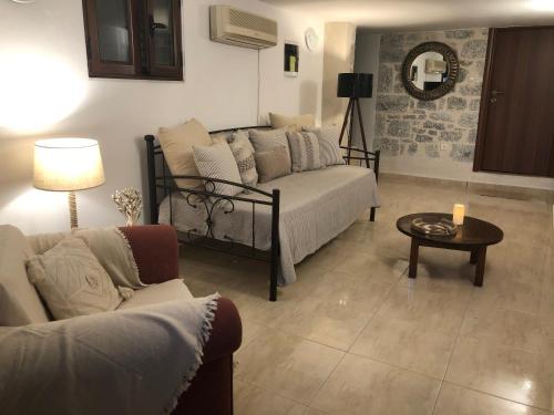 a living room with a couch and a table at Kamares Cave House 3 in Gerolimenas