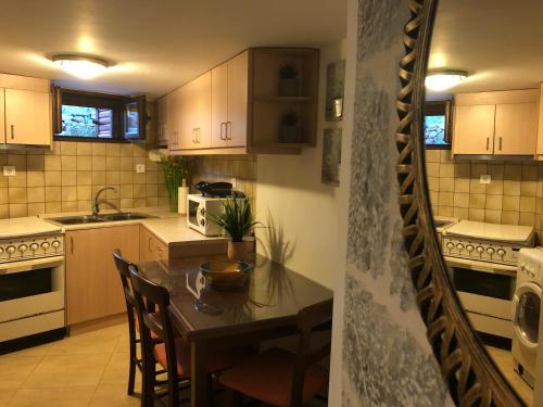 a kitchen with a table and chairs and a kitchen with white appliances at Kamares Cave House 3 in Gerolimenas
