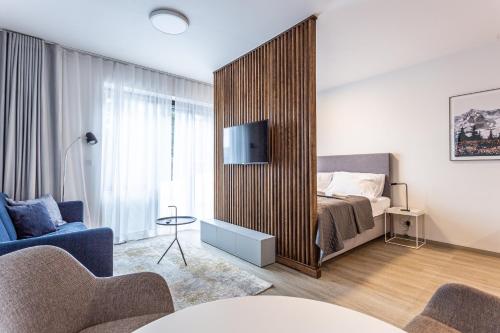 a bedroom with a bed with a large wooden partition at Ski Chalet Klínovec in Loučná pod Klínovcem