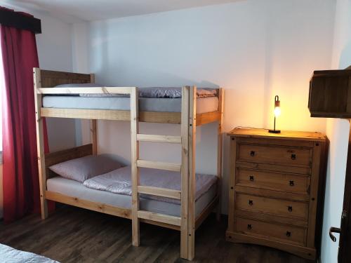 two bunk beds in a room with a dresser at Penzion u Pinkasů s wellness in Jablunkov