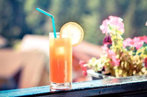 a drink sitting on a table with a lemon slice at House of Dracula Hotel in Poiana Brasov