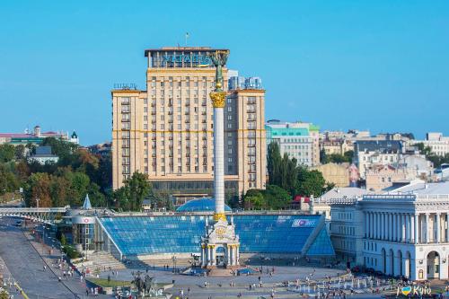 a large building with a clock tower in a city at Ukraine Hotel in Kyiv