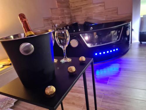 a black table with a wine glass and a stove at Apartament z jacuzzi Kraków in Kraków