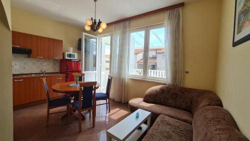 a living room with a couch and a table at Apartments Suvaljko in Orebić