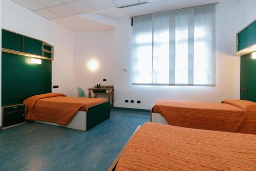 a hospital room with two beds and a window at Open011 in Turin