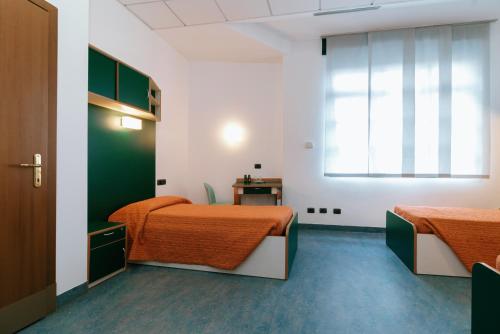 a room with two beds and a window at Open011 in Turin