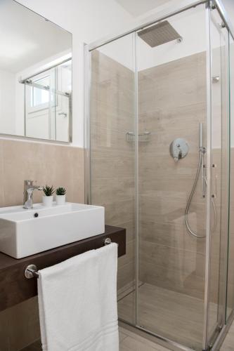 a bathroom with a sink and a shower at Hotel Raffaello in Bellaria-Igea Marina