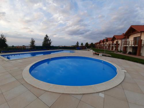 a large blue swimming pool on a patio at Morskie Opowieści in Żarnowska