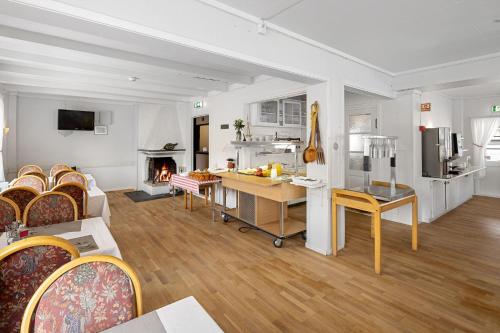 a kitchen and living room with white walls and wood floors at Ulvik Camping in Ulvik