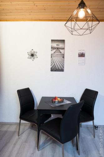 a dining room with a table and two chairs at FeWo/GZ Hannelore Müller in Leienfels